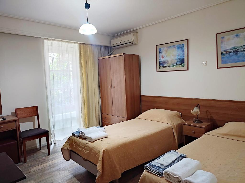 a hotel room with two beds and a window at ASTY in Mytilene