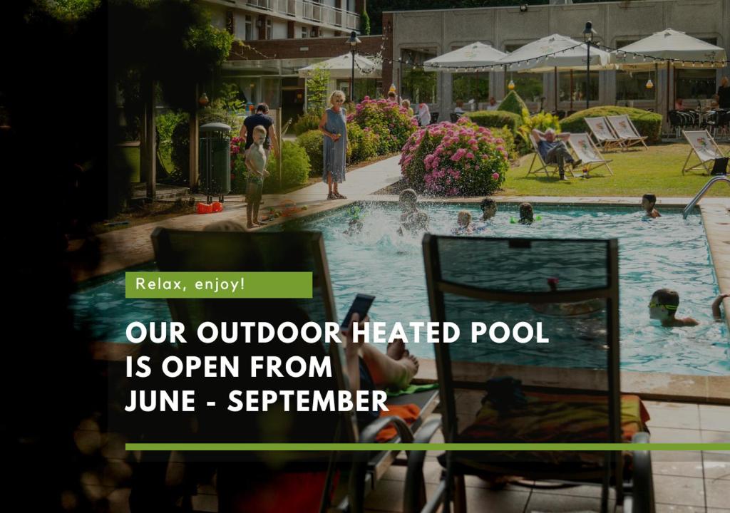 an outdoor heated pool is open from june september with people standing around at Green Park Hotel Brugge in Bruges