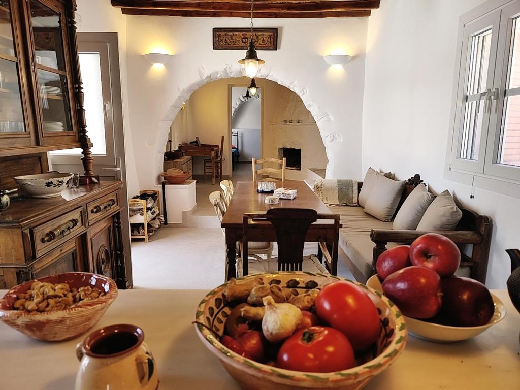 a kitchen with bowls of fruit on a table at Orania, heaven in Mykonos in Agios Sostis Mykonos