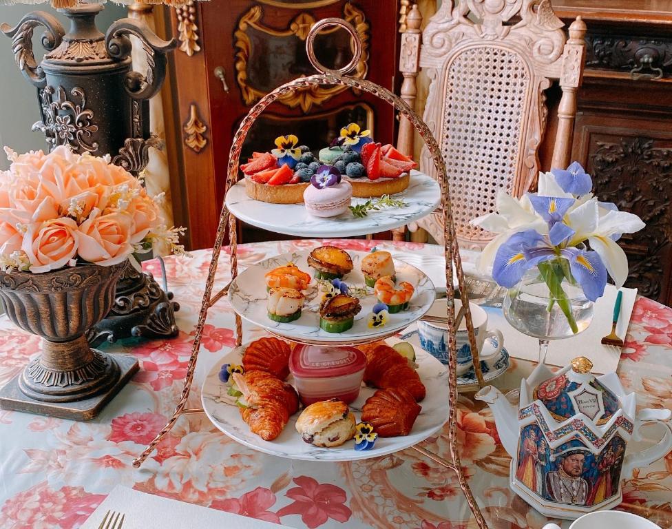 a table topped with three plates of pastries and desserts at England Castle B&amp;B in Wujie