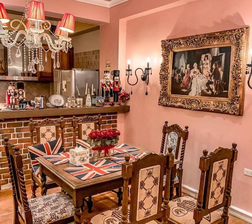 a dining room with a table and a picture on the wall at England Castle B&amp;B in Wujie