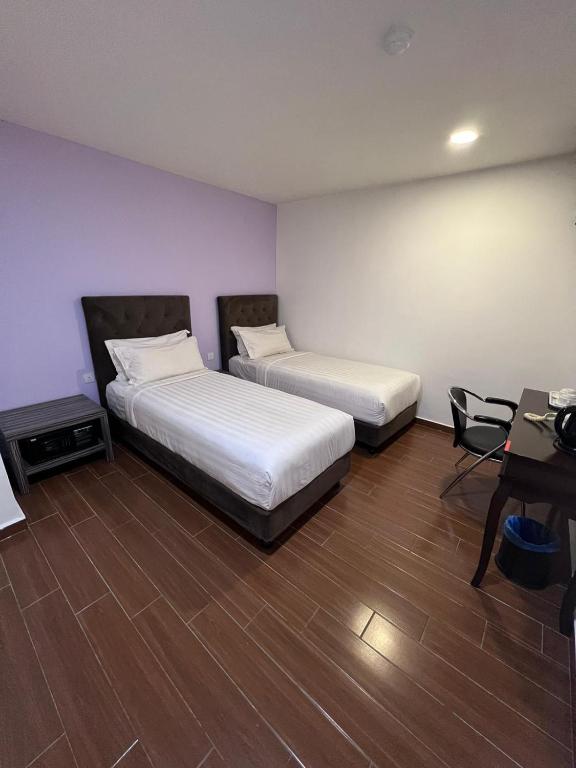 Postel nebo postele na pokoji v ubytování Elmark Hotel Johor