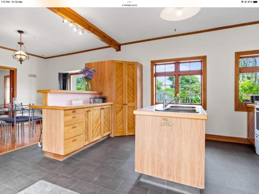 uma cozinha com um lavatório e uma bancada em Northern Holiday Cottage em Whangarei