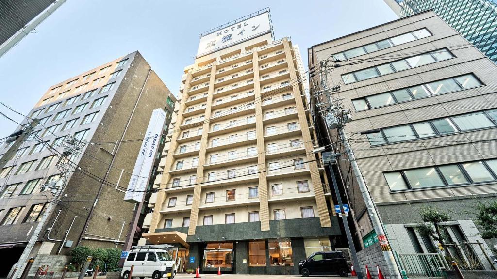a tall building in the middle of two tall buildings at Toyoko Inn Osaka Umeda Nakatsu No.1 in Osaka