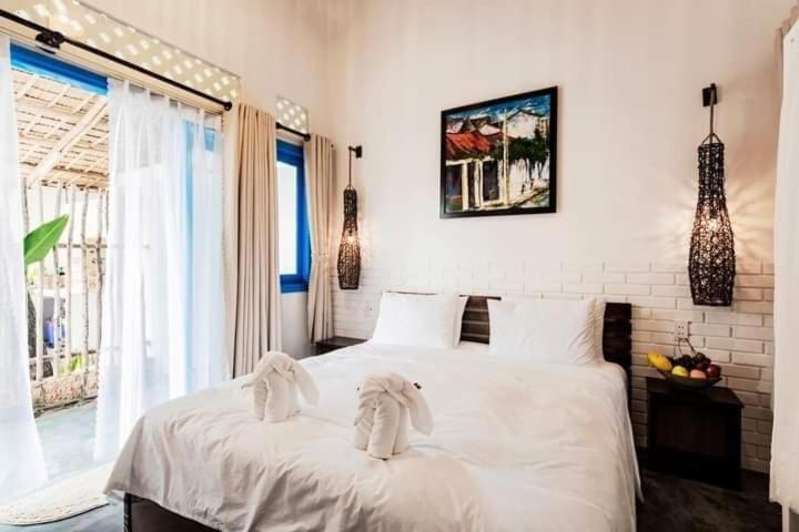 Giường trong phòng chung tại Cashew Tree Bungalow