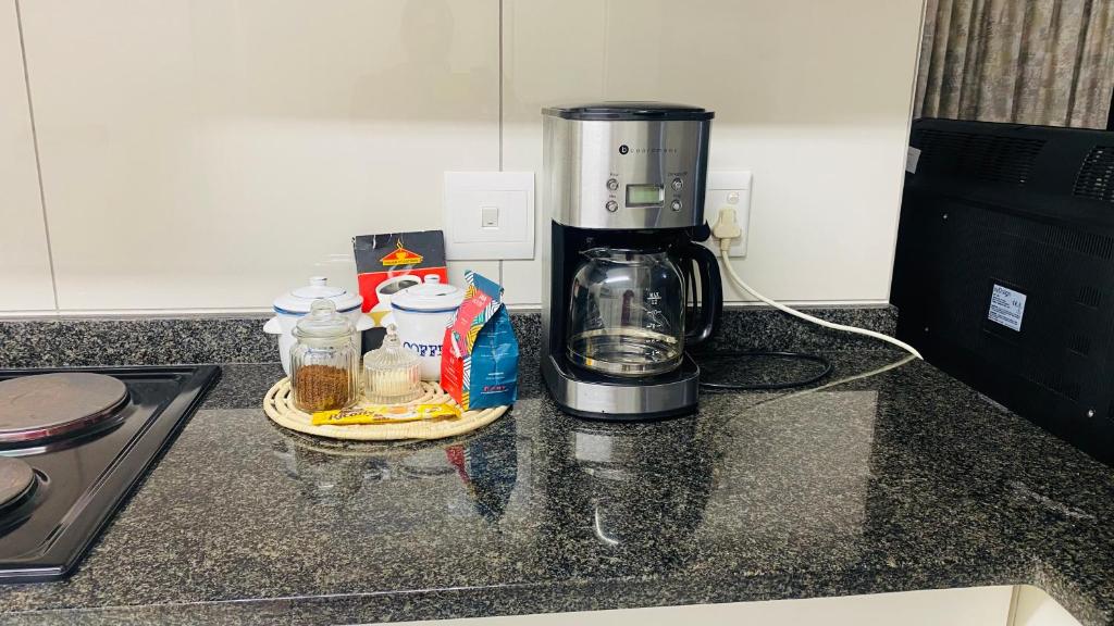 a coffee maker sitting on top of a kitchen counter at La Lucia Sleepover in Durban