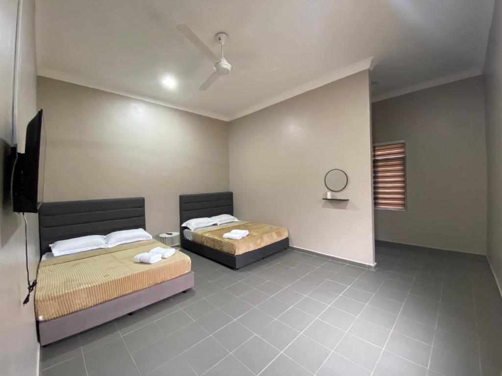 Postel nebo postele na pokoji v ubytování Sasuka Guesthouse (Muslim Sahaja)