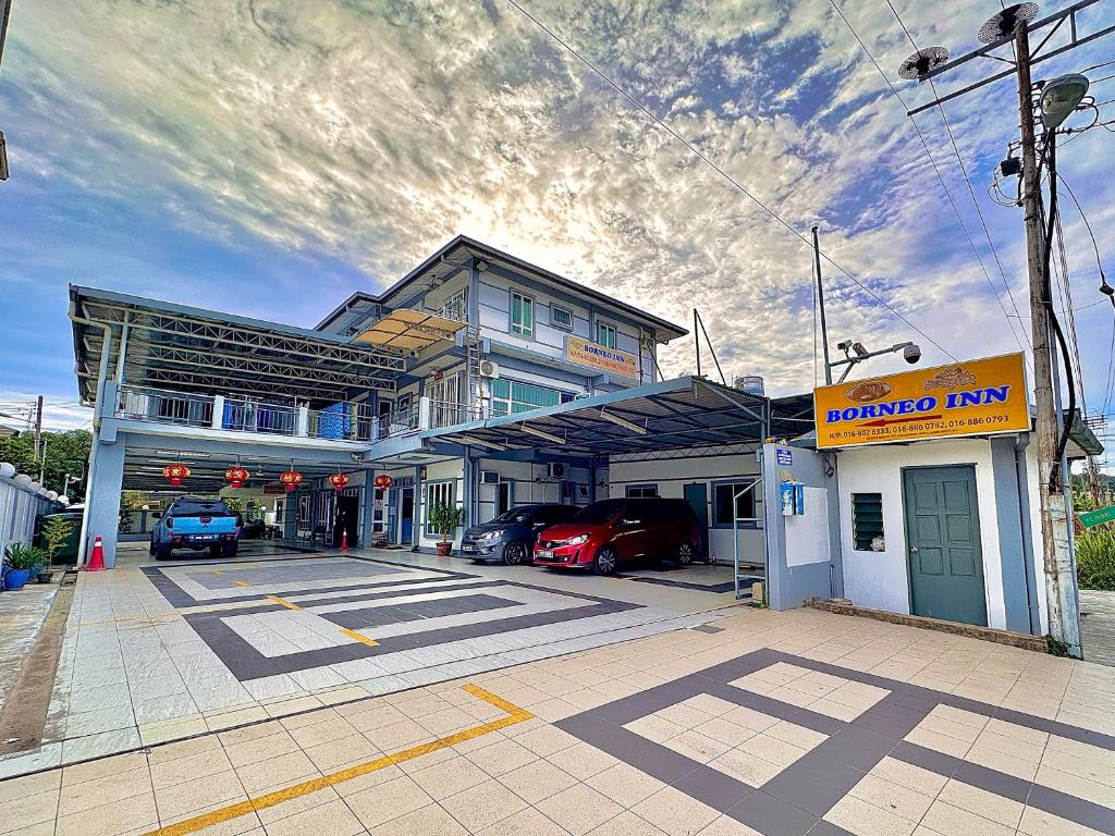 a gas station with cars parked in front of it at Borneo Inn in Kota Kinabalu
