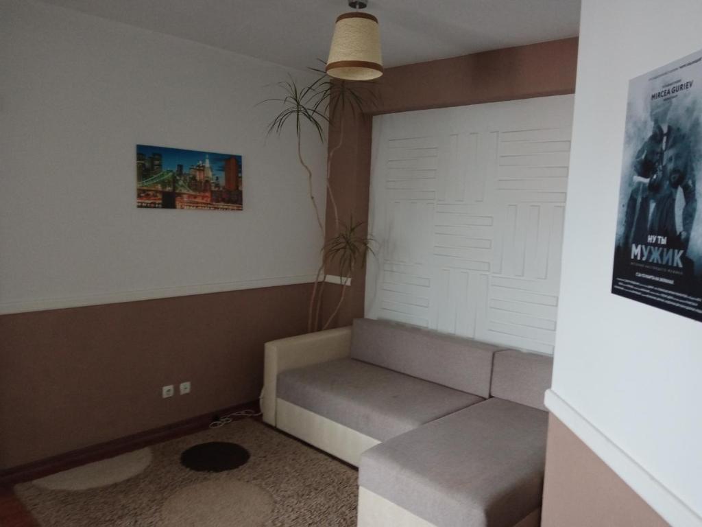 a room with a couch and a white door at modern home in Chişinău