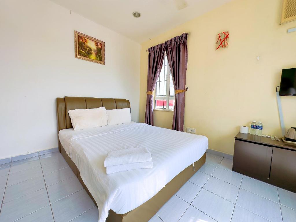 Postel nebo postele na pokoji v ubytování Borneo Inn
