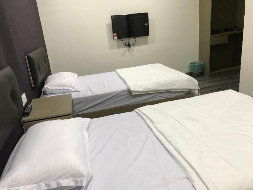 Postel nebo postele na pokoji v ubytování Z Stay Inn Hotel