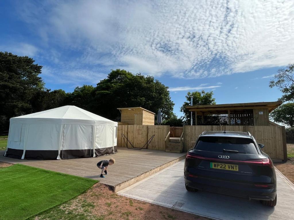a car parked in a driveway next to a tent at Dukeries Retreat in Retford