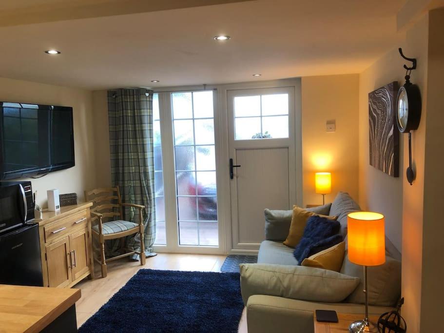 a living room with a couch and a tv at Adorable 1 bedroom apartment in Ironbridge in Telford
