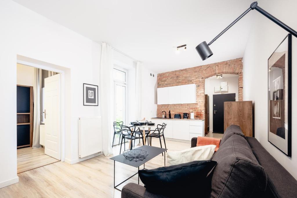 a living room with a couch and a table at Apartamenty Pamiątkowa 11, 2 rooms, self check in 24h in Poznań