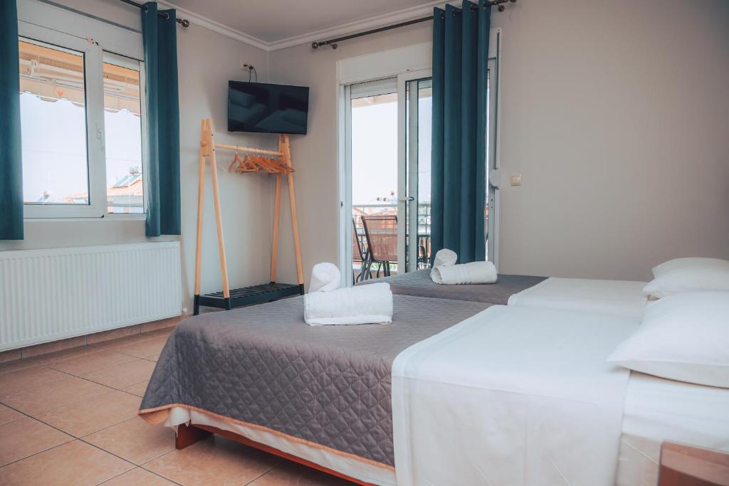 Postel nebo postele na pokoji v ubytování Dionysos Rooms