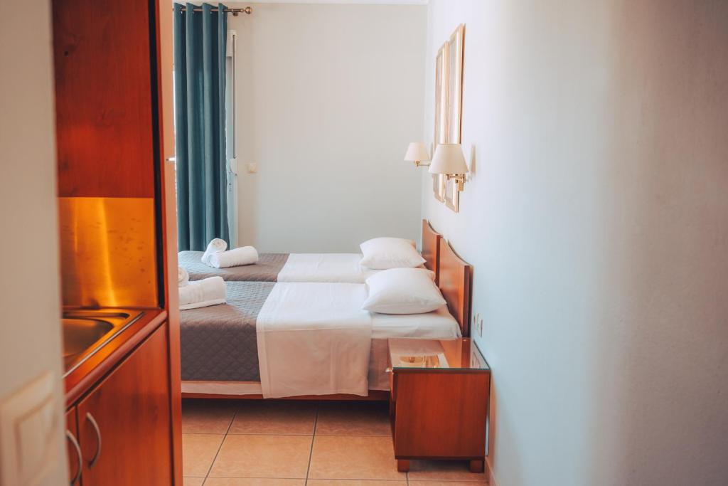 Postel nebo postele na pokoji v ubytování Dionysos Rooms