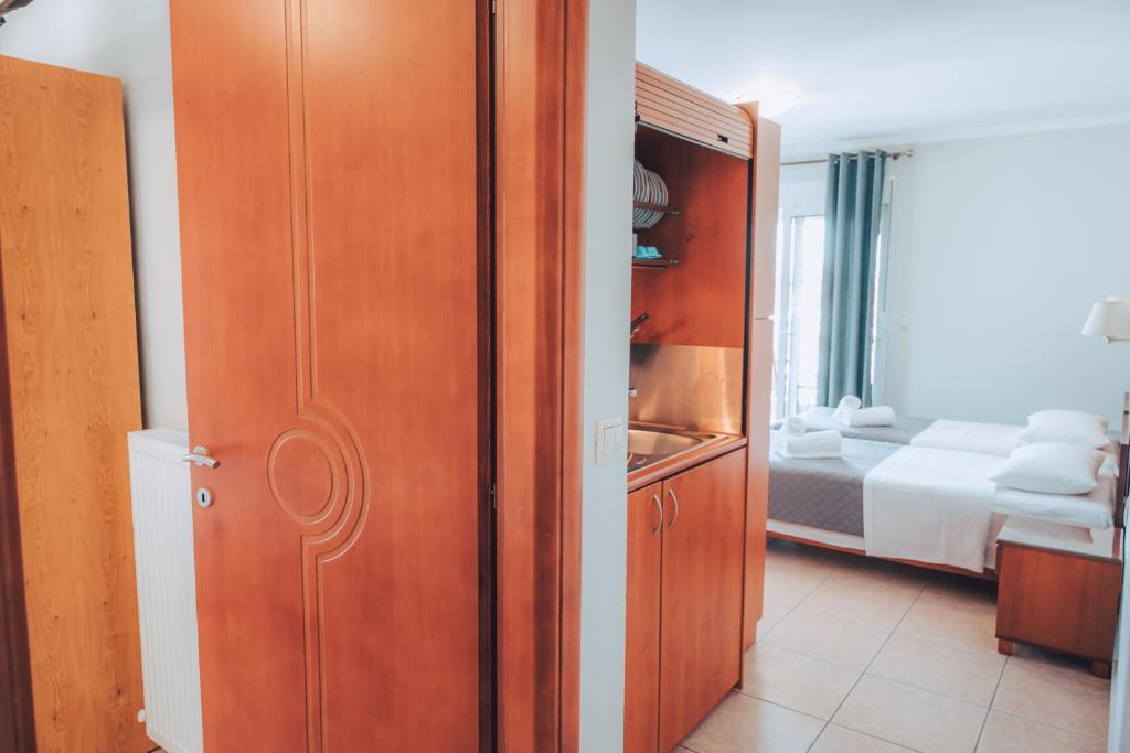 Postel nebo postele na pokoji v ubytování Dionysos Rooms