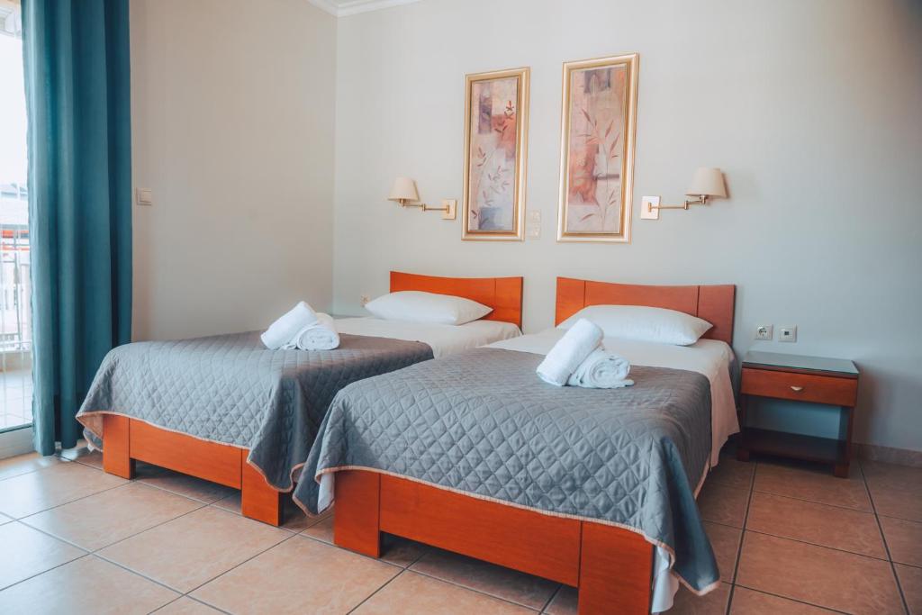 Postel nebo postele na pokoji v ubytování Dionysos Rooms