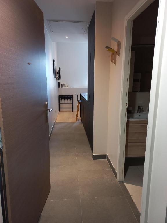 a hallway with a hallway leading to a kitchen with a door at Villa Saint Enogat in Aix-les-Bains