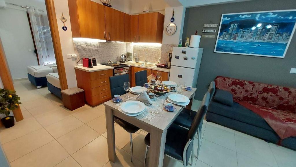 a small kitchen with a table and a couch at Modern Apartment Kallithea 2 in Kallithea Halkidikis