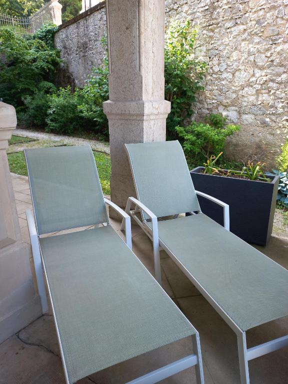 two chairs and a table on a patio at Villa Saint Enogat in Aix-les-Bains