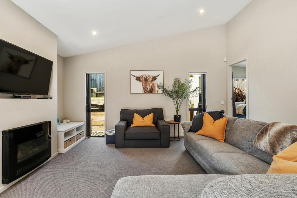 a living room with a couch and a tv at If I can dream in Taupo