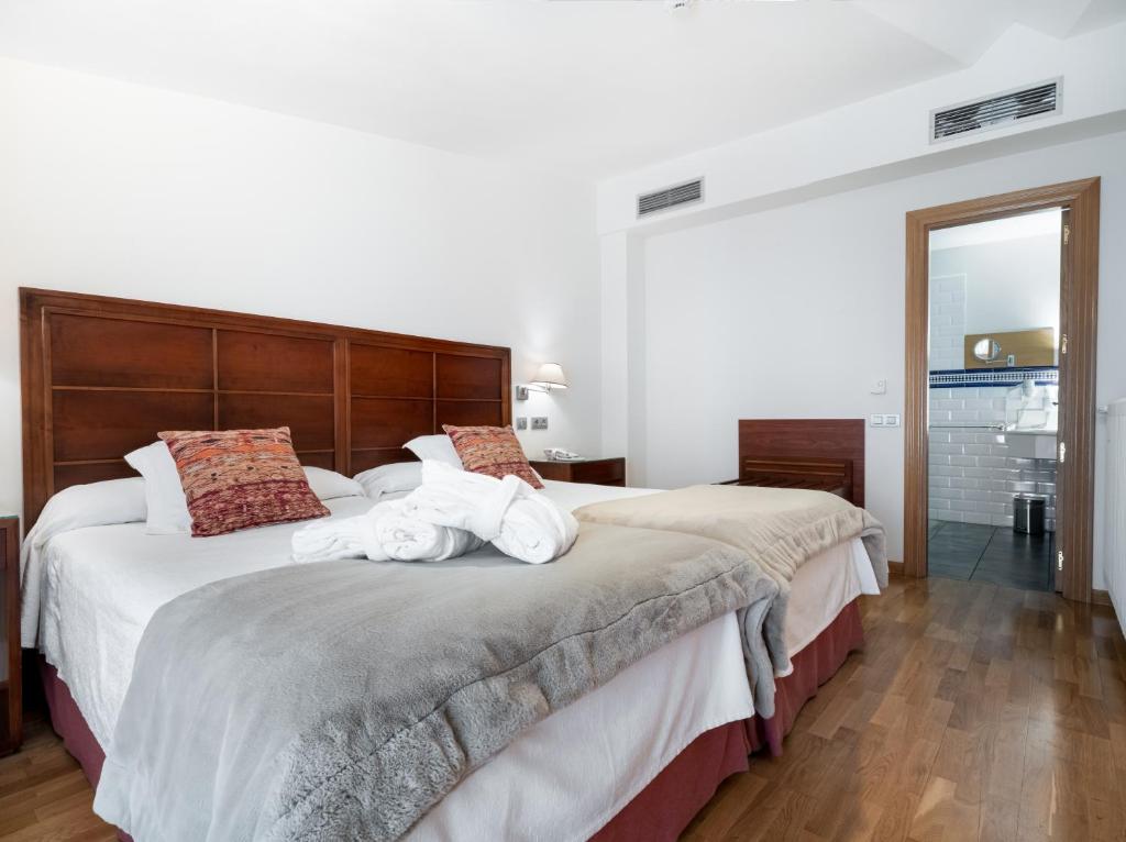 Postel nebo postele na pokoji v ubytování Hotel Villa Virginia