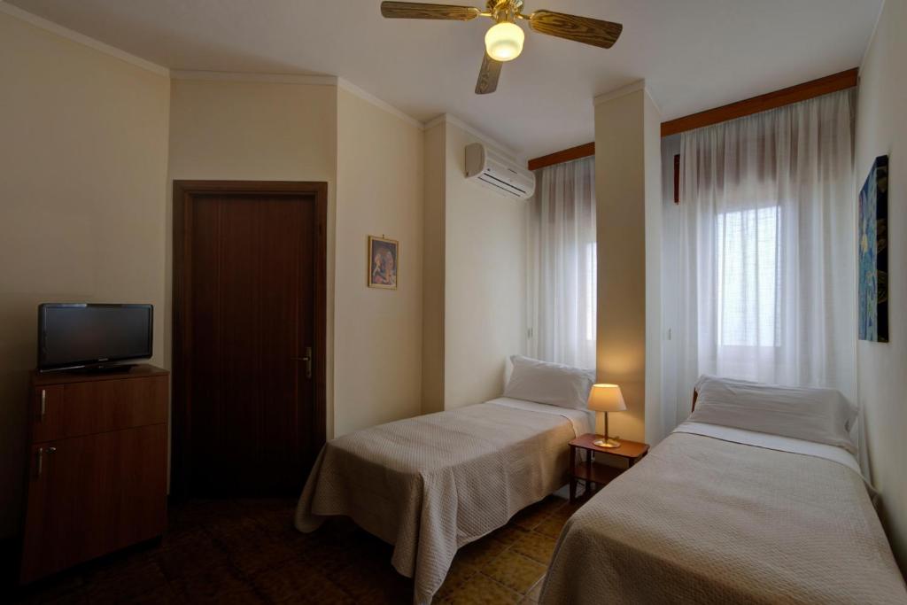 Postel nebo postele na pokoji v ubytování Hotel Sporting
