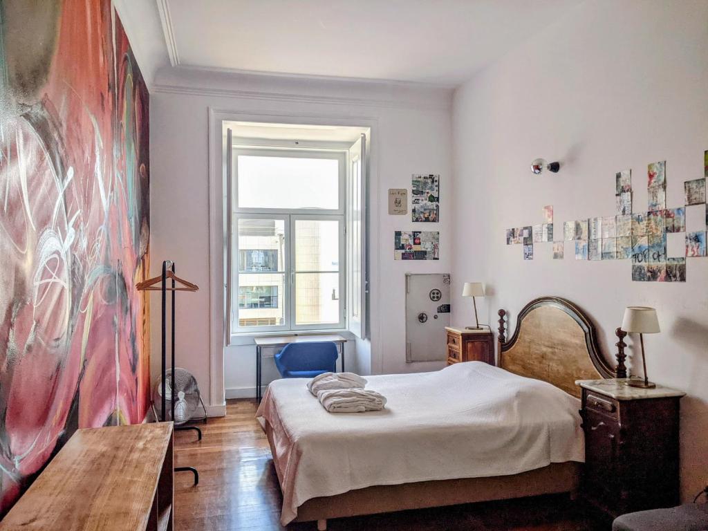 Postel nebo postele na pokoji v ubytování Lost Lisbon :: Cais House