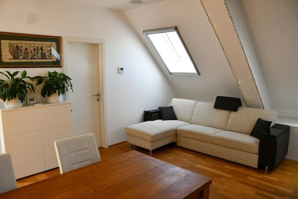 a living room with a couch and a table at Stairway to Ljubljana Apartment in Ljubljana