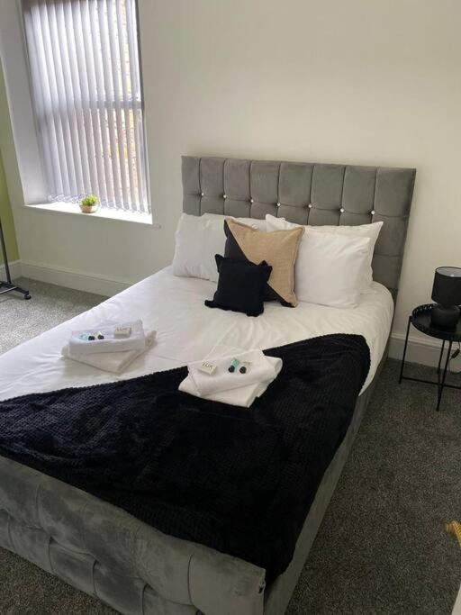 a bedroom with a bed with two towels on it at Belle Vue in Pontnewynydd