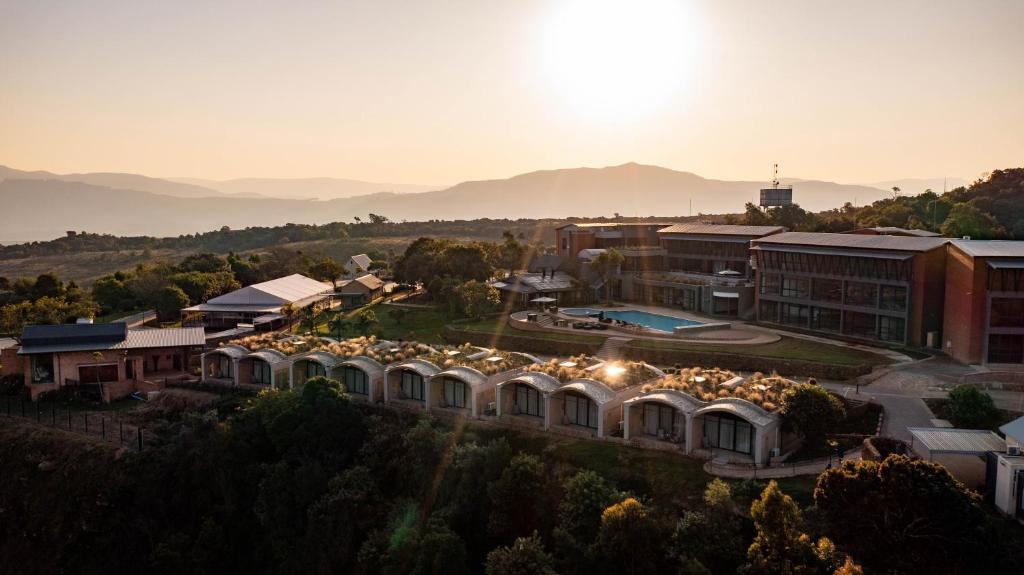 an aerial view of a building with the sun setting at Angels View Hotel in Graskop
