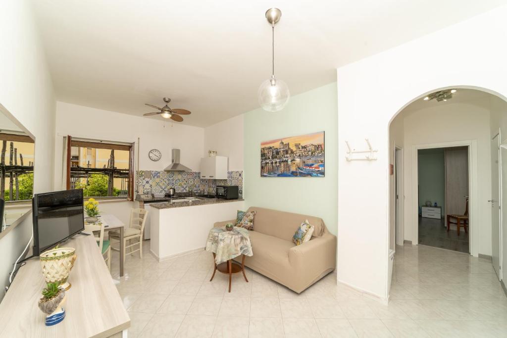 a living room with a couch and a kitchen at John House in Sorrento