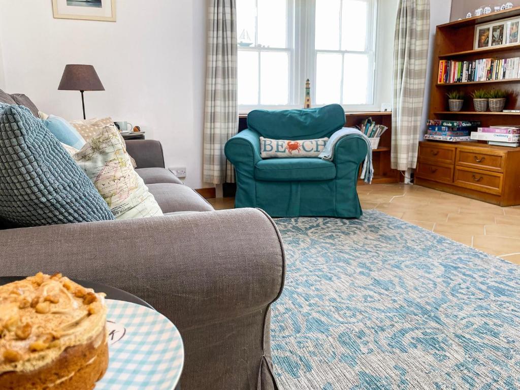 a living room with a couch and a chair at Seaview Cottage - 27991 in Dunure