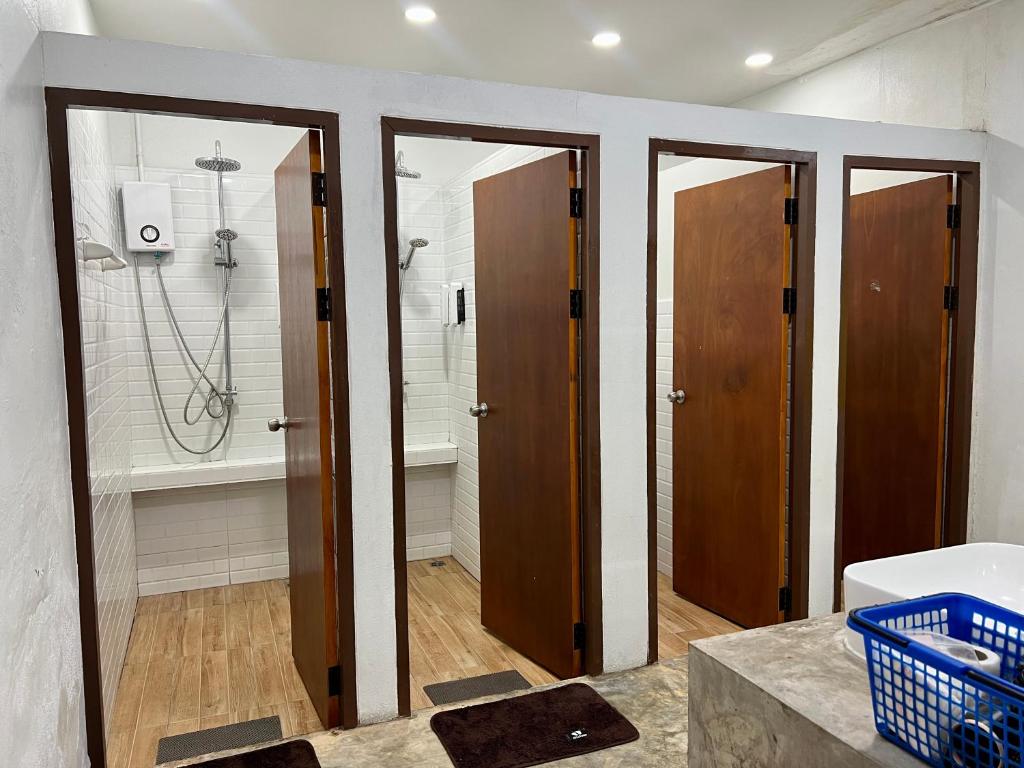 a bathroom with three doors and a shower at Together Backpackers Hostel in Chiang Rai