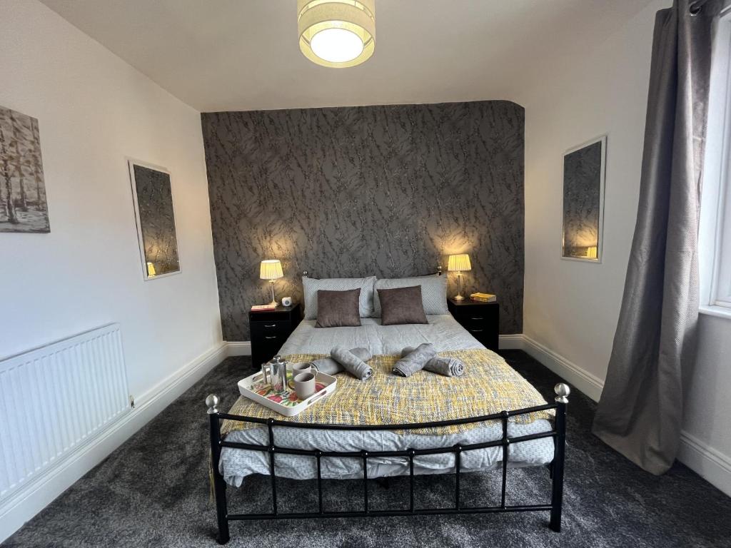 ウィガンにあるModernised central Wigan townhouse sleeps up to 6のベッドルーム1室(ベッド1台、ナイトスタンド2台、ランプ2つ付)