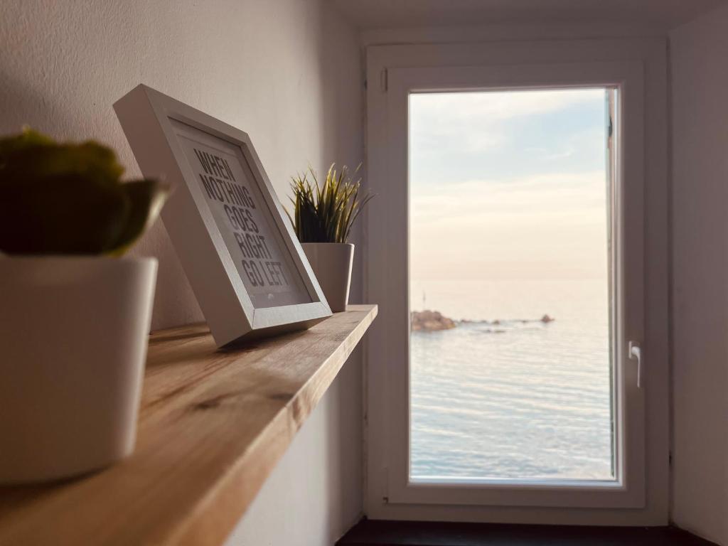 a window in a room with a view of the ocean at La Finestra Sul Mare - [Sea View] in Genova