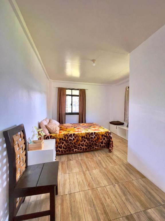 a hotel room with a bed and a couch at Andrew & Mary's Lodging House in Sagada