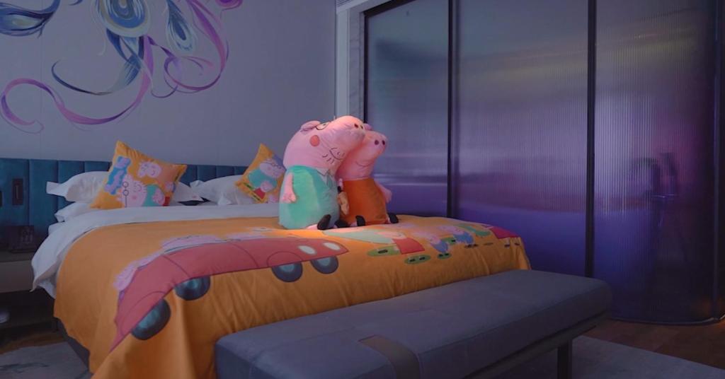 a bedroom with a bed with a toy elephant on it at TIDE Hotel in Chaozhou