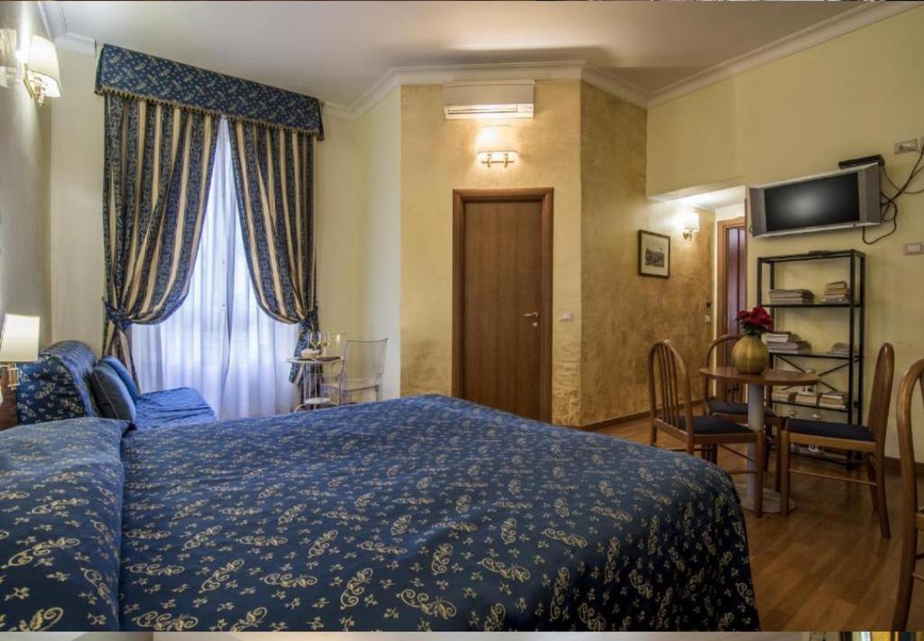 a bedroom with a blue bed and a window at Opera Italian Suite in Rome