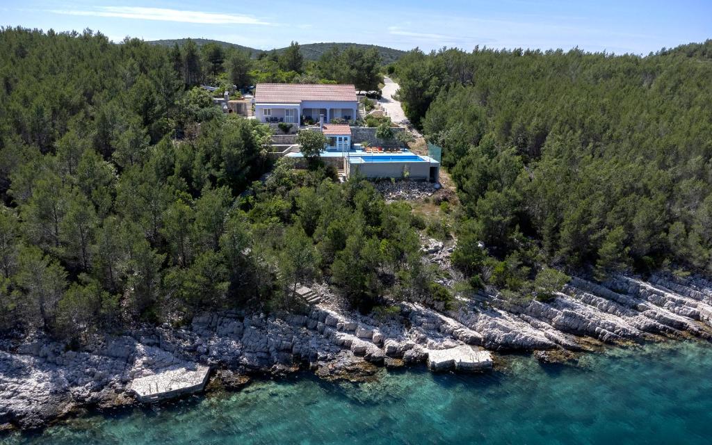 an aerial view of a house next to the water at Villa Serenity in Hvar