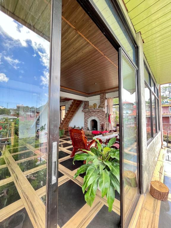 an open porch with sliding glass doors on a house at Andrew & Mary's Lodging House in Sagada