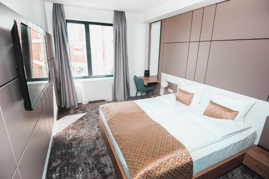 Postel nebo postele na pokoji v ubytování Hotel Koncept Residence