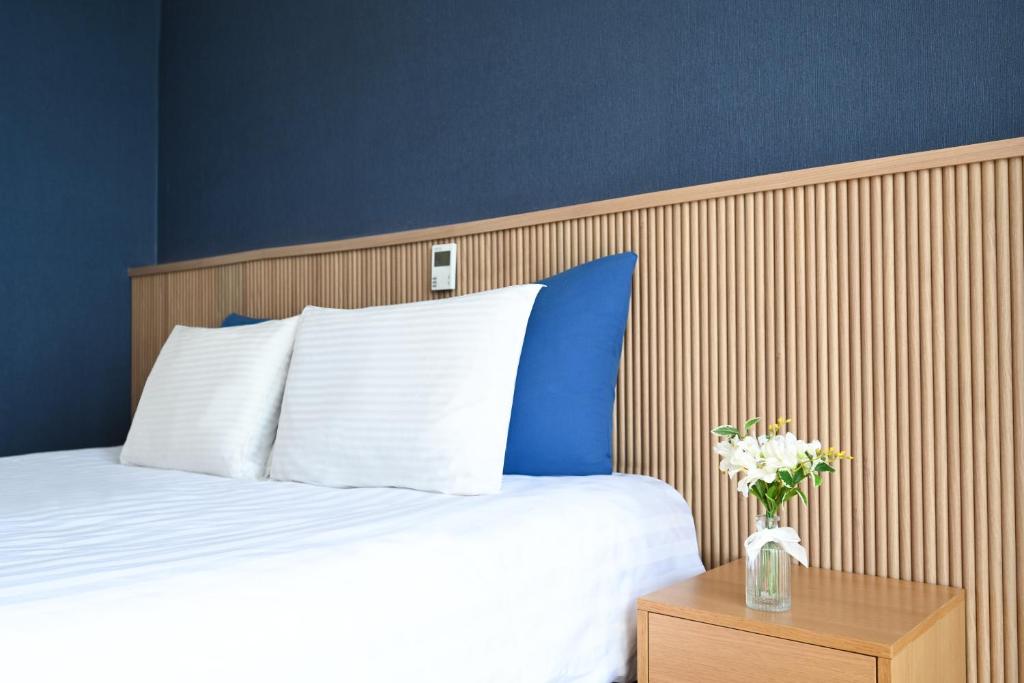 Postel nebo postele na pokoji v ubytování Kolon Seacloud Hotel