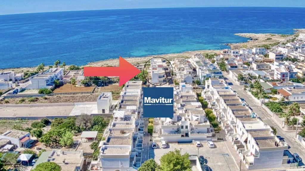 an aerial view of a city with a red arrow at Mavitur Salento Apartments in Torre San Giovanni Ugento