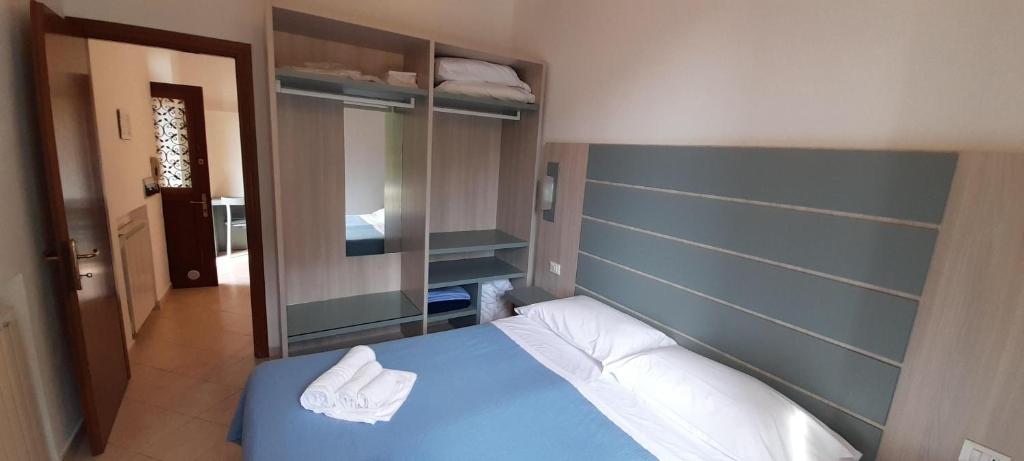 a bedroom with a blue bed with white pillows at Hotel Villa Argentina in Riomaggiore