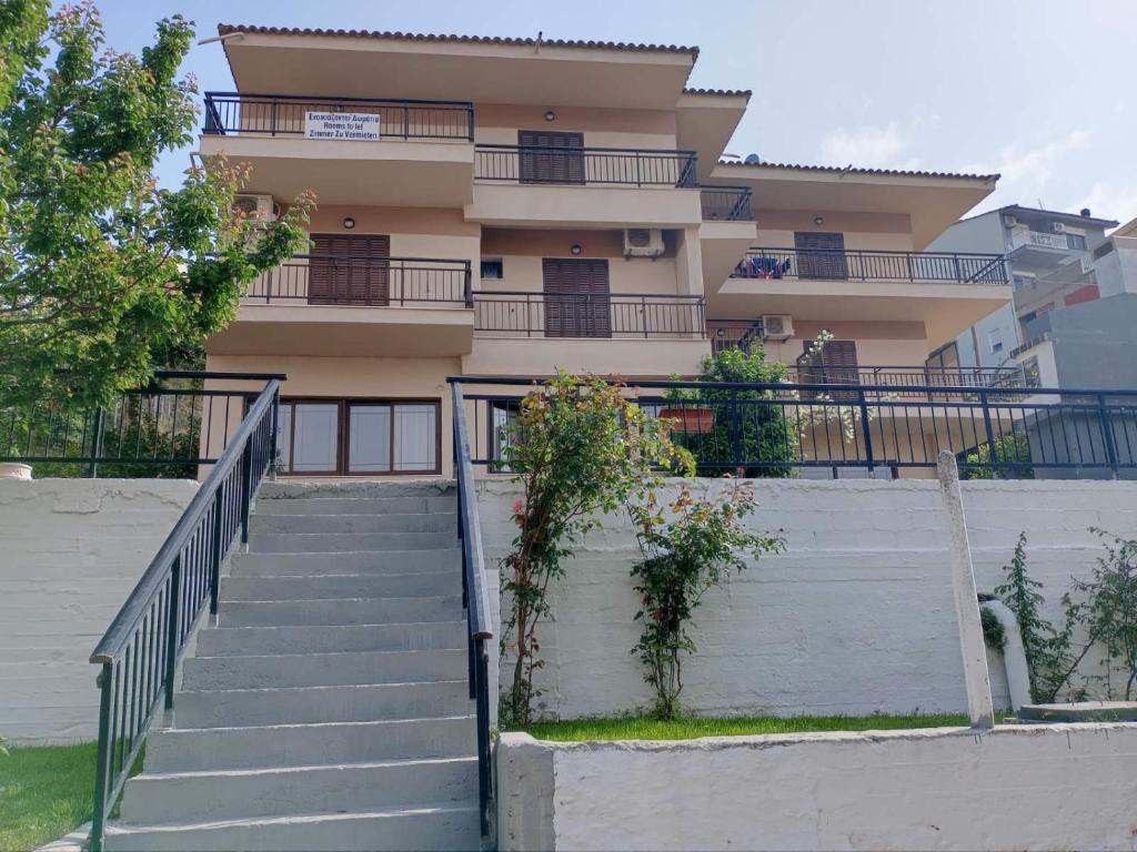 a building with stairs in front of it at Papas Studios in Skala Marion