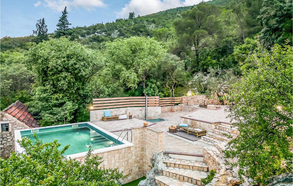 una casa con piscina y árboles en Cozy Home In Vrgorac With Outdoor Swimming Pool en Vrgorac