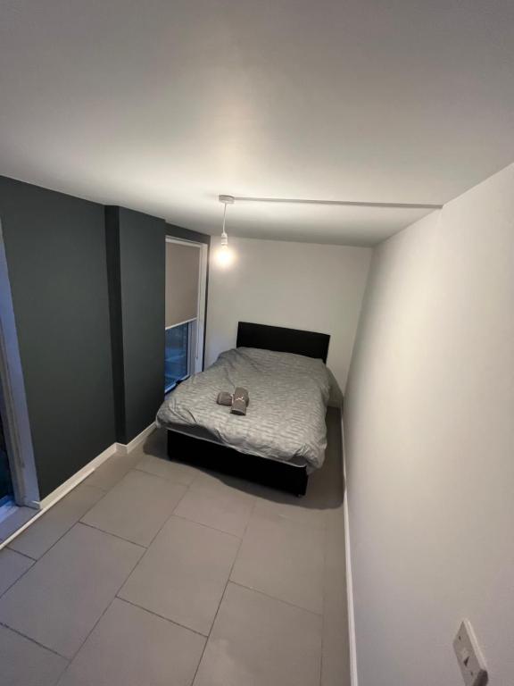 a small bedroom with a bed in the corner at Cozy two bed apartment in Clapham 1 in London