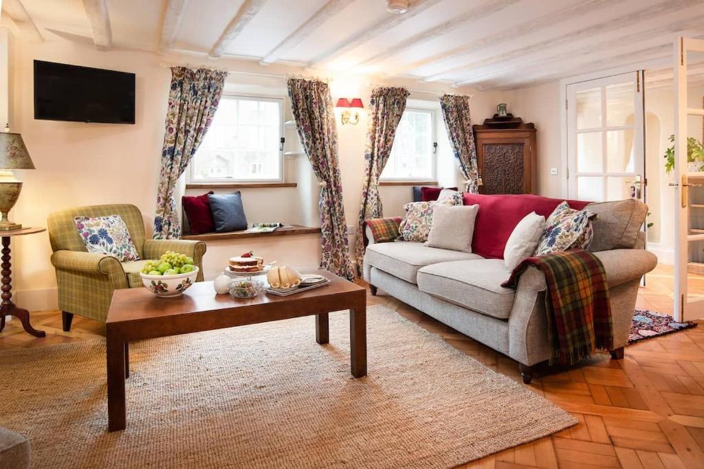 a living room with a couch and a coffee table at The Craftsman's Cottage in Alnwick